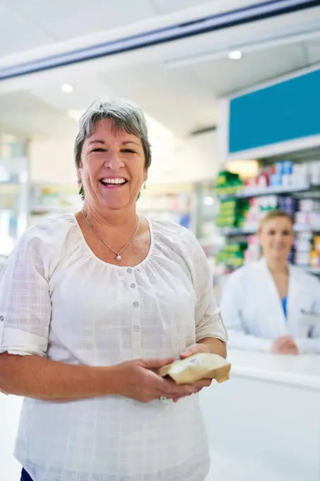 They always live up to my expectations here. Portrait of a happy mature woman buying medication at a pharmacy.