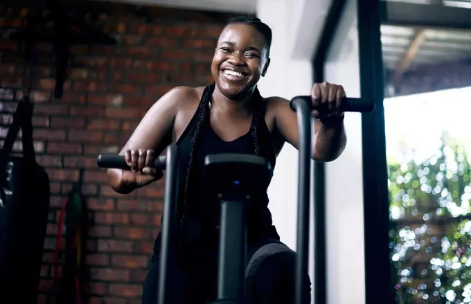 Upping my endurance. Cropped portrait of an attractive young female athlete working out on an elliptical machine in the gym.