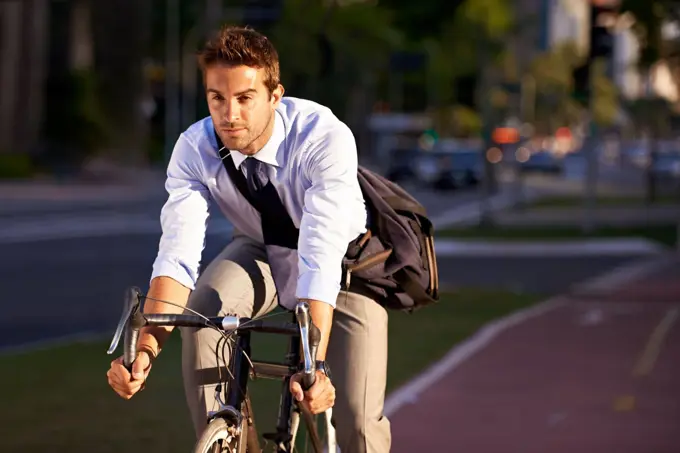 Really getting some exercise on the way to work. a businessman commuting to work with his bicycle.