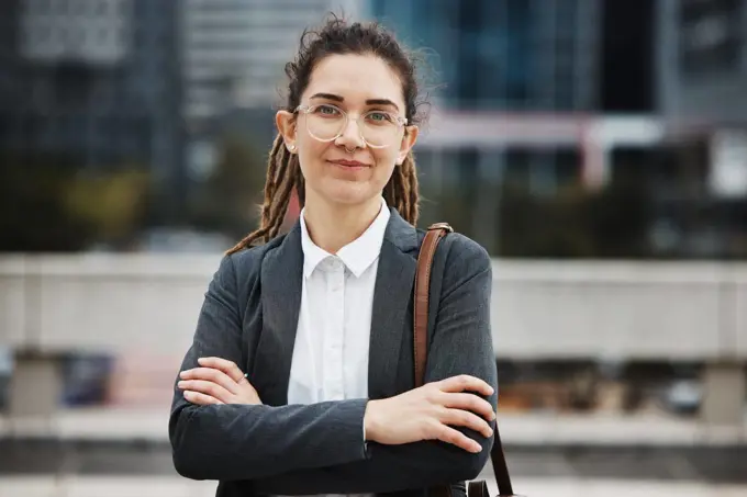 Business woman, professional portrait and arms crossed outdoor with a career and creative job pride. City, entrepreneur and work commute in morning with female person from New York in urban town