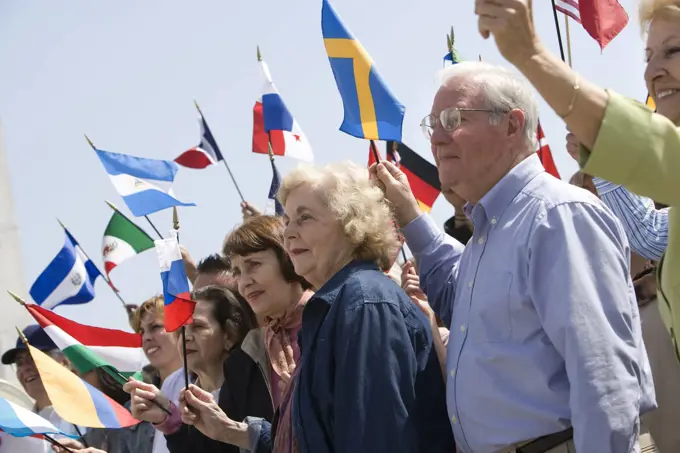 Crowd holding up National flags