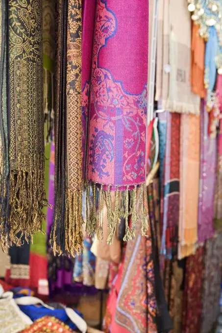 Colourful pashminas and fabrics for sale at Bur Dubai souq, Dubai, UAE