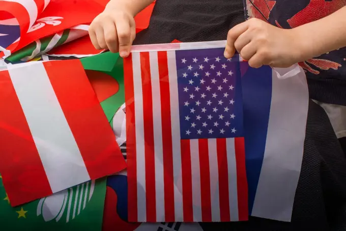 Child hand holding an American flag in hand