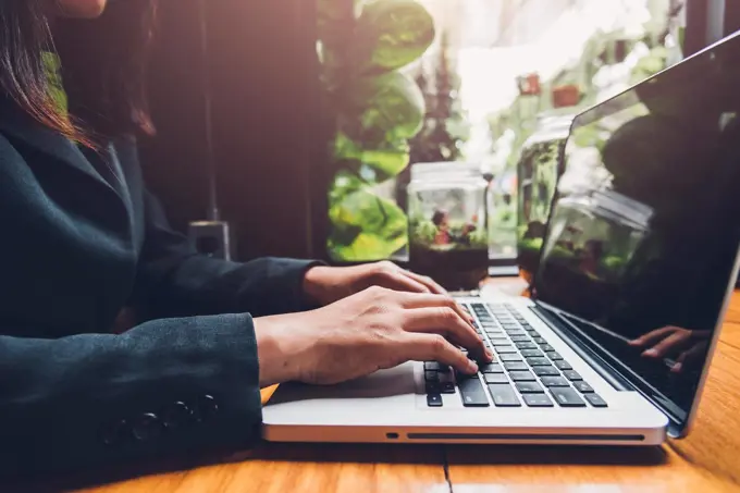 Young businesswoman is working by typing on his computer laptop