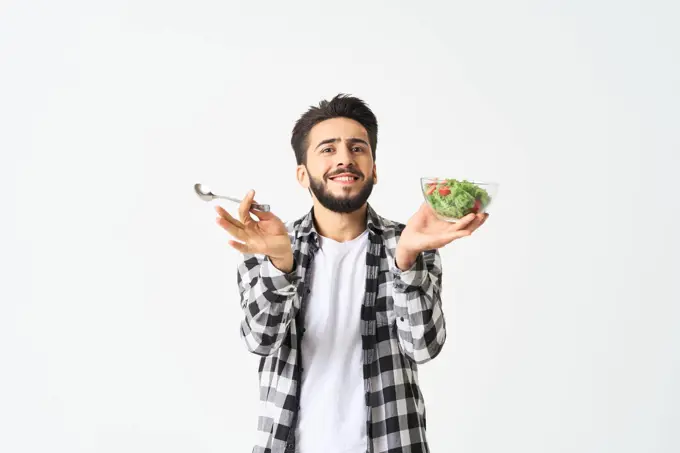 man in plaid shirt eating salad healthy food