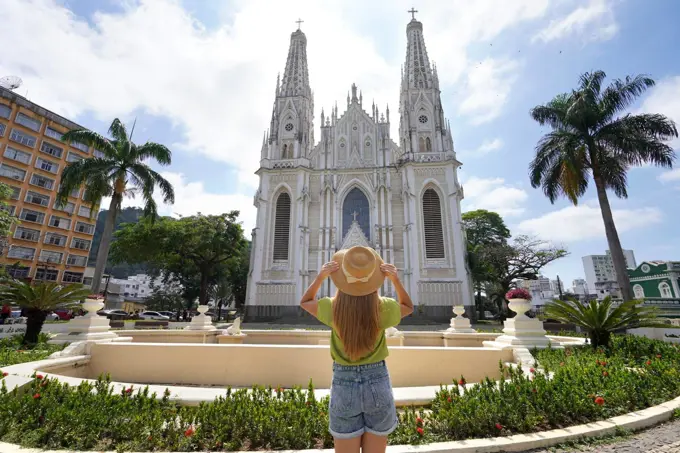 Tourism in Brazil. Back view of young traveler woman looking the Vitoria Cathedral in Espirito Santo State, Brazil.