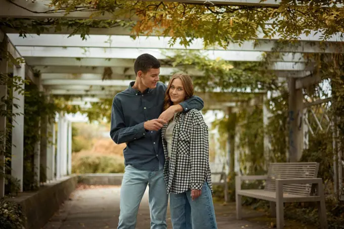 Warm Embrace of Teen Love in the Autumn Park. Capturing Teen Moments: Love Blossoms in Autumn's Embrace. Teenagers in Love: Embracing the Autumn Vibe