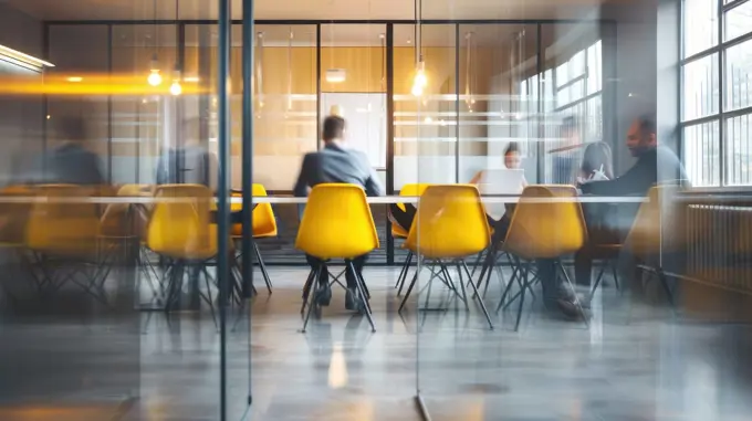 Dynamic Office Meeting in Modern Workspace with Vibrant Motion against Minimalist Background.