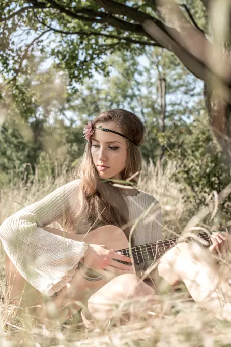 Young singer song-writer musician guitar girl in autumn forest, Vienna, Austria (model-released)