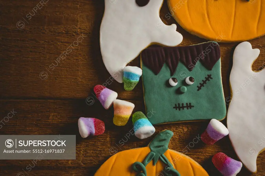 Overhead close up of cookies with candies on wooden table