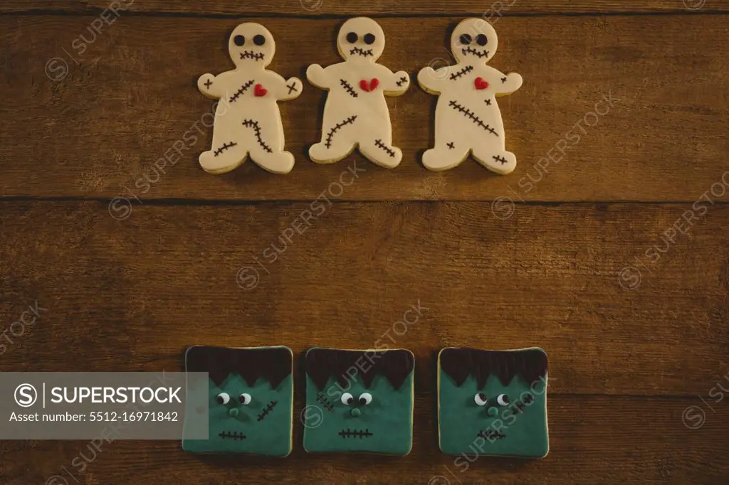 Overhead view of Halloween cookies arranged on wooden table