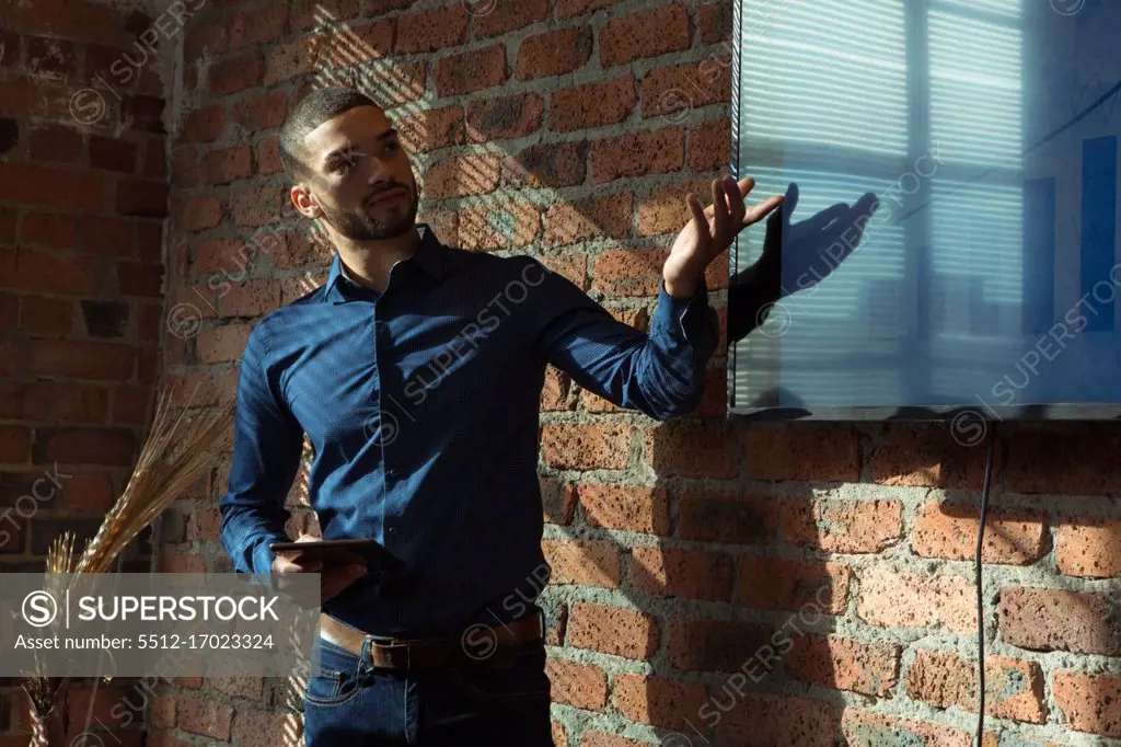 Executives giving presentation on screen in office