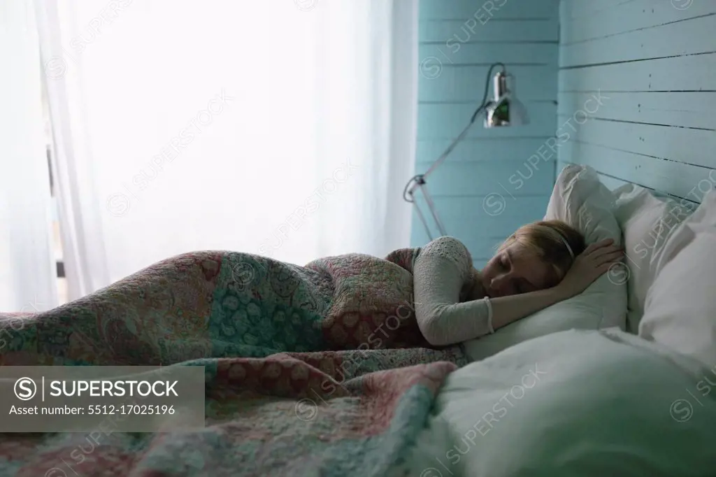 Beautiful woman sleeping in bedroom at home