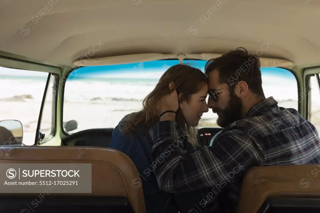 Romantic couple embracing in vehicle on roadtrip