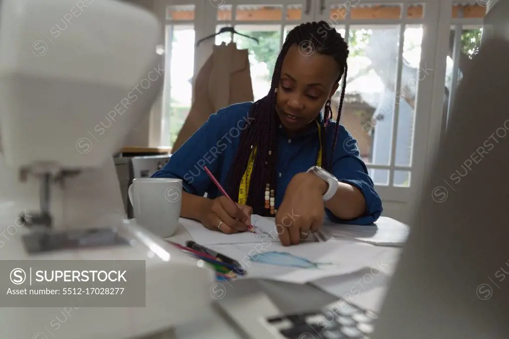 Woman writing about her work in paper at home