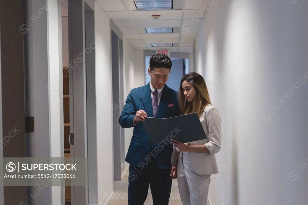 Side view of businessmen discussing a file in the modern office  