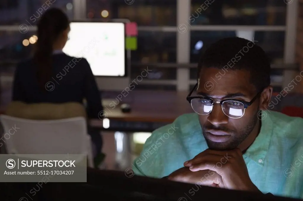 Front view of African-american Thoughtful businessman working in office in over computer