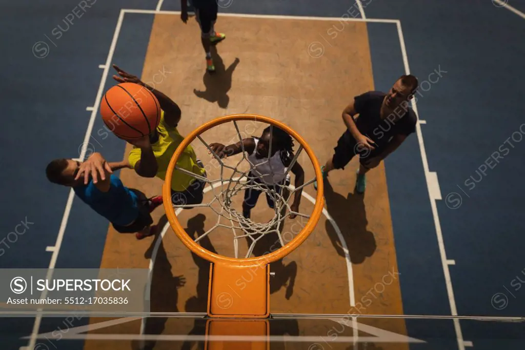 High angle view of basketball players playing basketball at basketball court