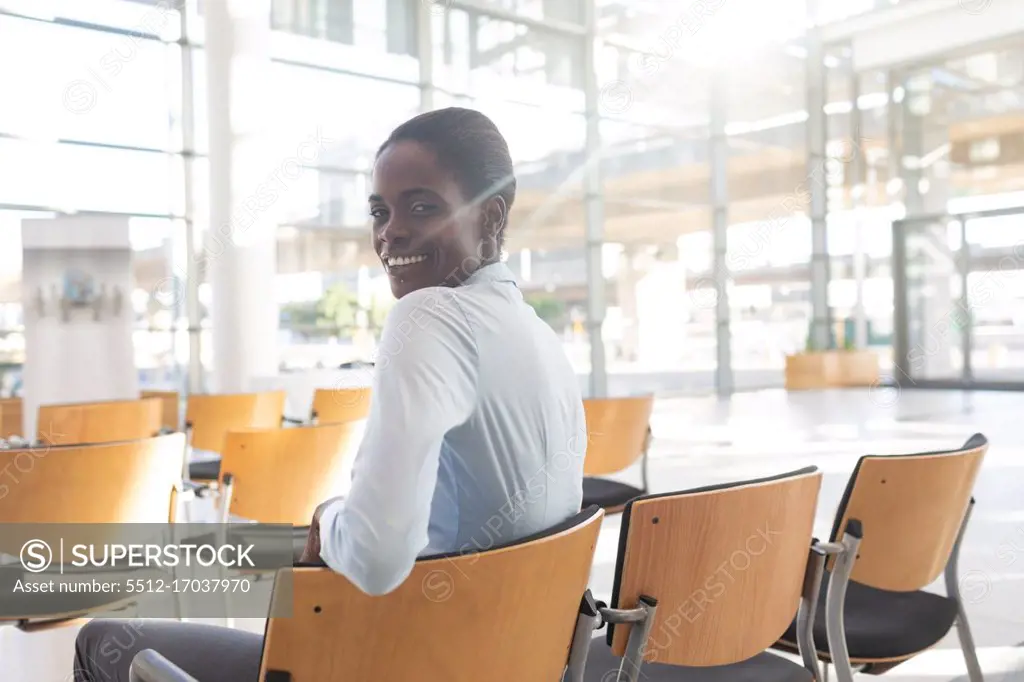 Side view of African-american woman sitting in conference room