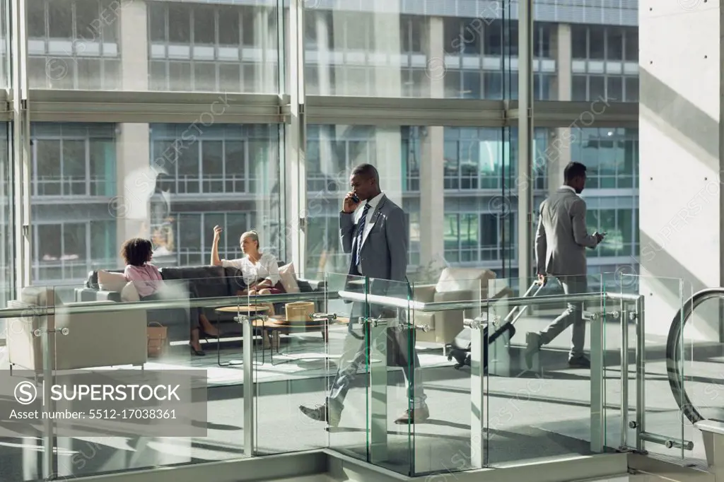 Side view of diverse business people walking in modern office 