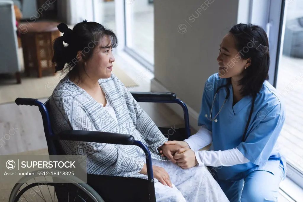 Asian Female Physiotherapist Treating Asian Female Patient At Her Home   5512 18418325.webp