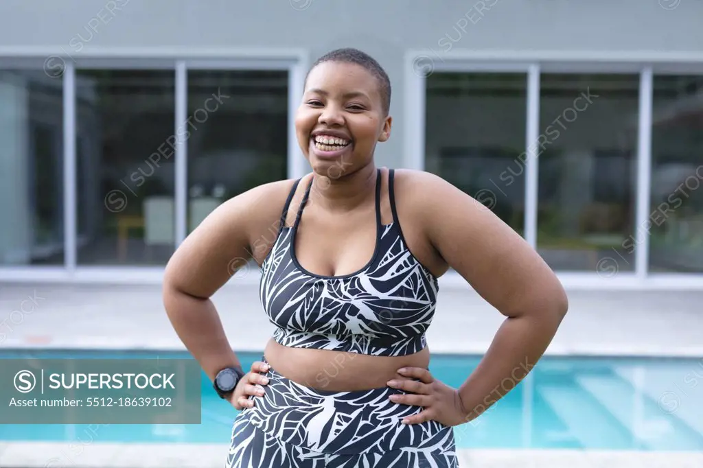 Happy african american plus size woman wearing sports clothes and looking at camera. fitness and healthy, active lifestyle.