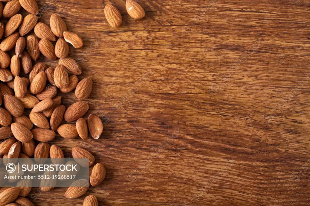 Directly above shot of nutritious almonds on wooden table with empty space. unaltered, healthy food, copy space, snack, organic, nut and dried food.