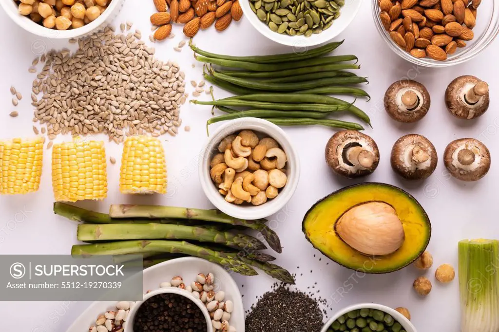 Overhead view of healthy food and ingredients arranged on white table, copy space. unaltered, food, preparation, healthy eating.