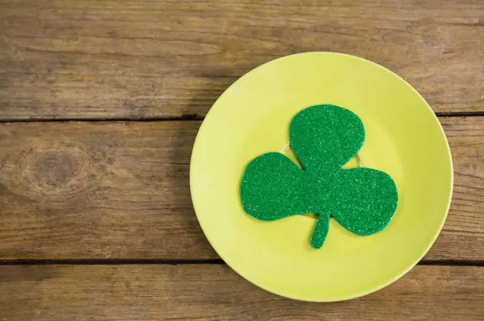 St Patricks Day shamrock kept in plate n wooden table