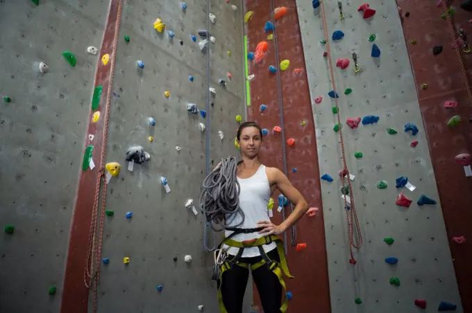 Portrait of woman standing with hands on hip in fitness studio