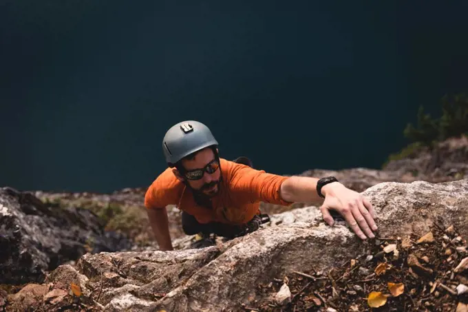 Determined rock climber climbing the rocky mountain