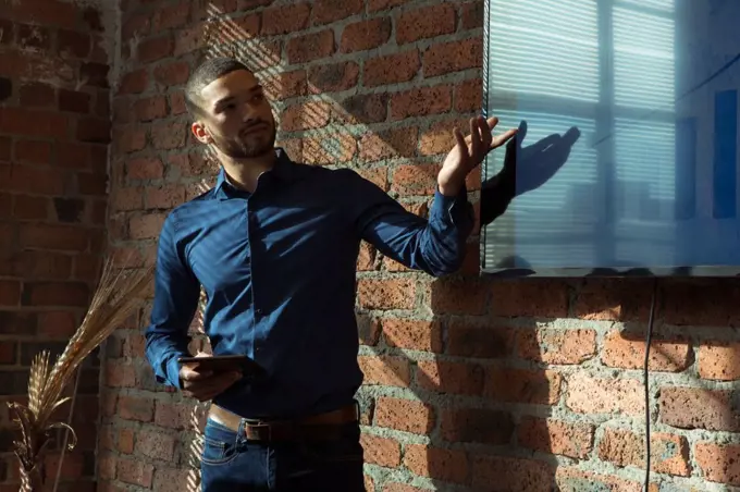 Executives giving presentation on screen in office