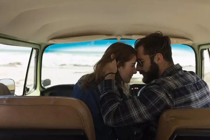 Romantic couple embracing in vehicle on roadtrip