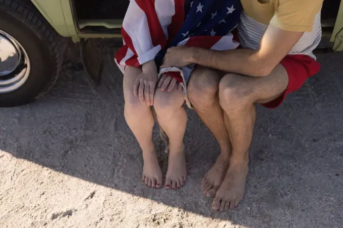 Low section of couple sitting in van on roadtrip