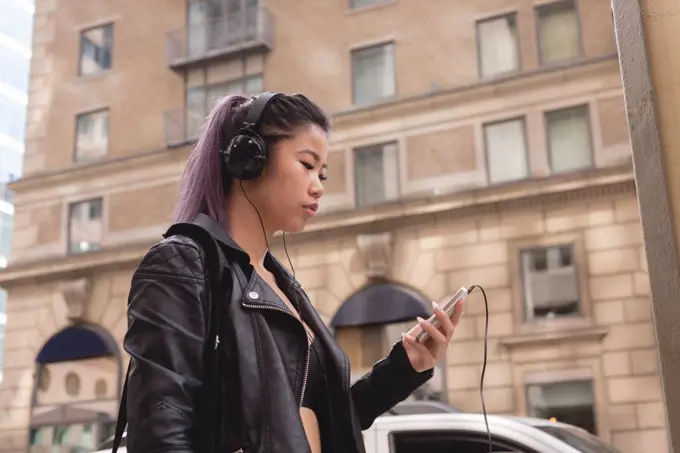 Beautiful woman listening music on mobile phone