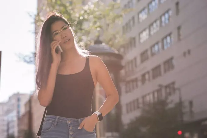 Pretty woman talking on mobile phone on street