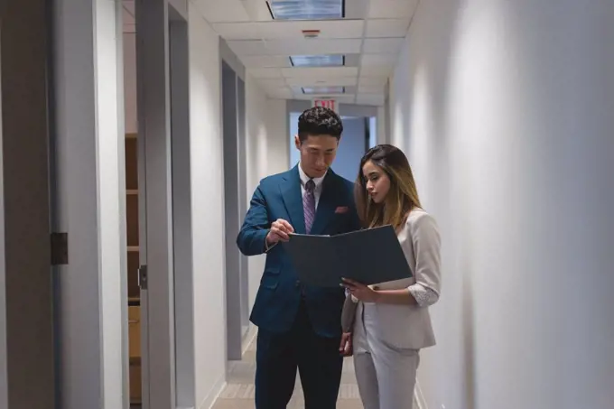 Side view of businessmen discussing a file in the modern office  