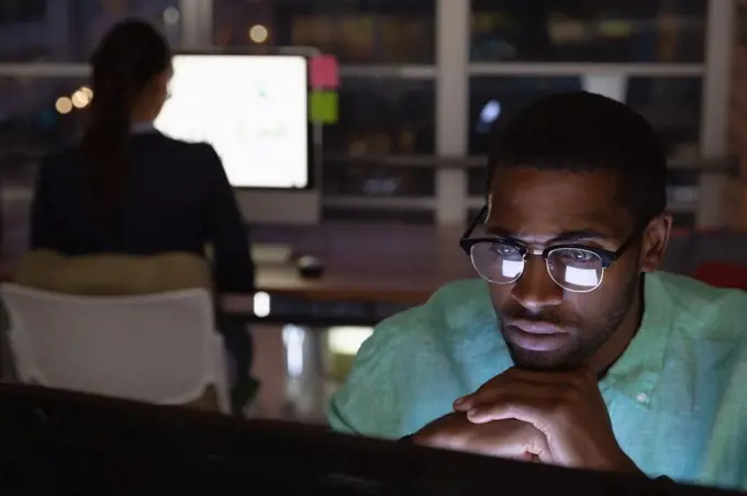 Front view of African-american Thoughtful businessman working in office in over computer