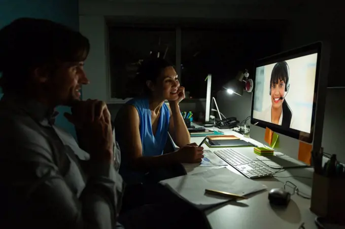 Side view of happy young multi-ethnic office executives making video conferencing at desk in a modern office 4k