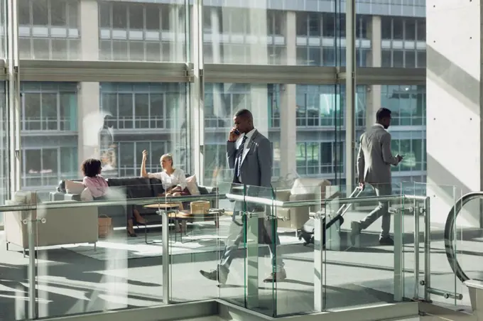 Side view of diverse business people walking in modern office 