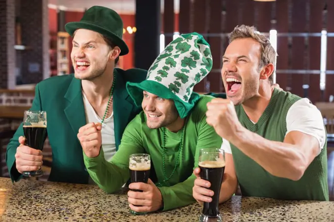 Men watching a game on tv in a bar