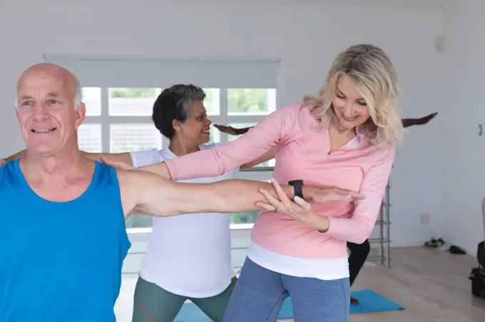 Diverse group of seniors taking part in fitness class at home. health fitness wellbeing at senior care home.