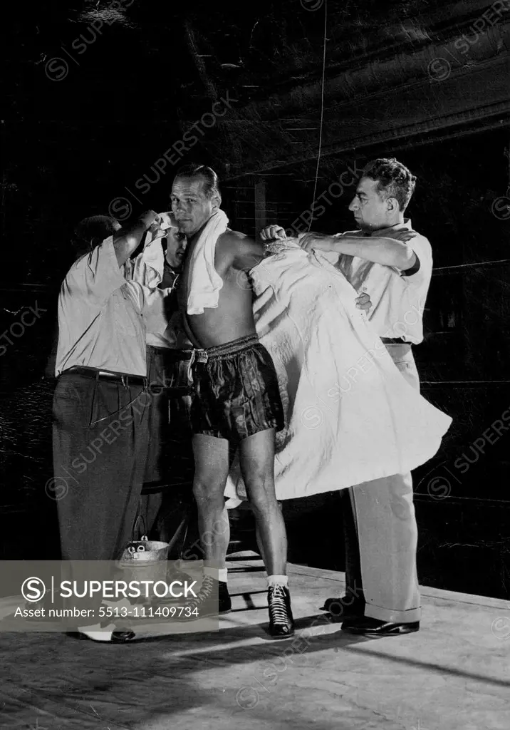 Zale's robe is removed so that he can wrap it loosely over his shoulders while waiting for the fight to begin. November 01, 1948. (Photo by Sporting Life).