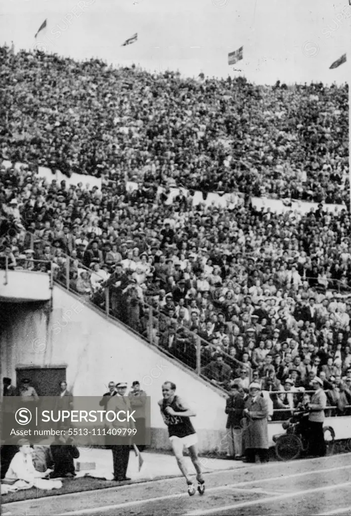 Zatopek Enters Stadium To Win Marathon -- The her of the VT Olympiad, Emil Zatopek of Czechoslovakia, enters the Olympic stadium at Helsinki today, July 27, just before winning the Olympic Marathon and his third gold medal of the Helsinki games. His time of two hours, 23 minutes, 3.2 seconds, is a new Olympic record. Earlier in the Olympiad, Zatopek won the 5,000 and 10,000 metre runs. The incredible Czech Zatopek took the Olympic marathon field along so fast that the first seven runners broke