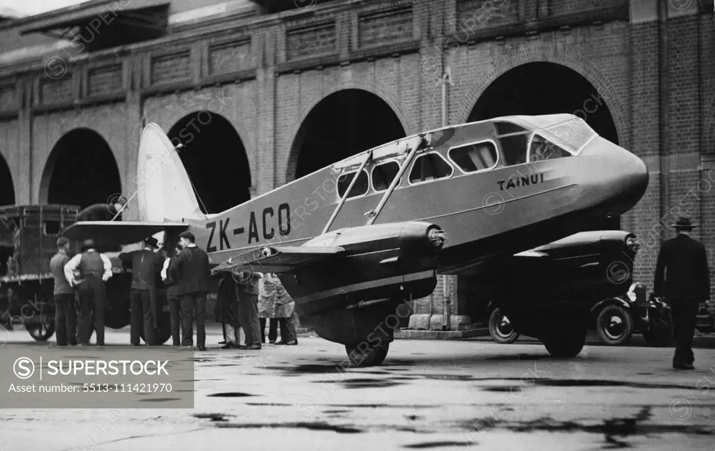 When Wings Weren't Wanted -- The big Dragon Rapide 'plane, Tainui, found its wheels more useful than its to-day. Its tail was fastened to a lorry outside a wharf at Daring Harbour, and it was towed through the streets to Mascot Aerodrome. The 'plane, which was used in the Centenary Air Race, arrived from New Zealand yesterday. It is here for the consideration of persons who may want to buy it. June 03, 1935.