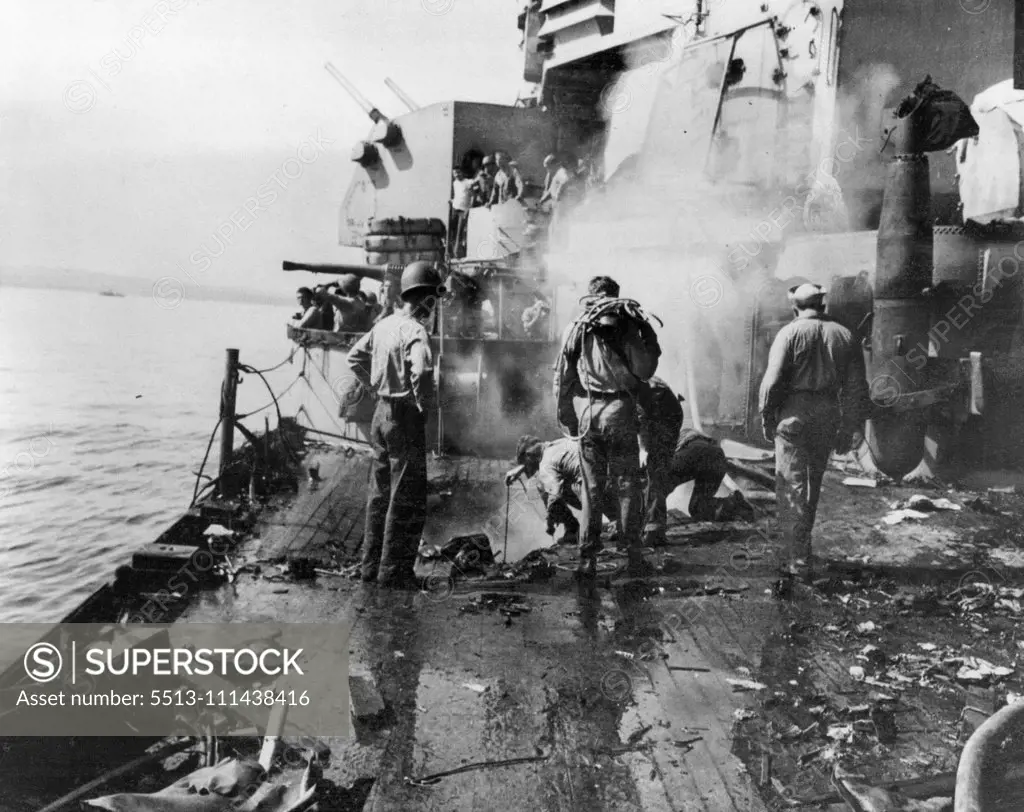 Strike Three -- And Still She Floats! -- Three times a victim of vicious enemy attack, the valiant USS Birmingham is back at sea -- still afloat in spite of her dep battle scars. First slashed by a Torpedo in 1943, Later riddled like a sleve when the USS Princeton blew up alongside her, The Birmingham suffered her most serious blow off Okinawa on May 4, 1945. Zooming out of the sun in a sttep dive, a Jap Kamikaze and its 500-pound bomb crashed just aft of the Birmingham's number 2 Turret. Forty-