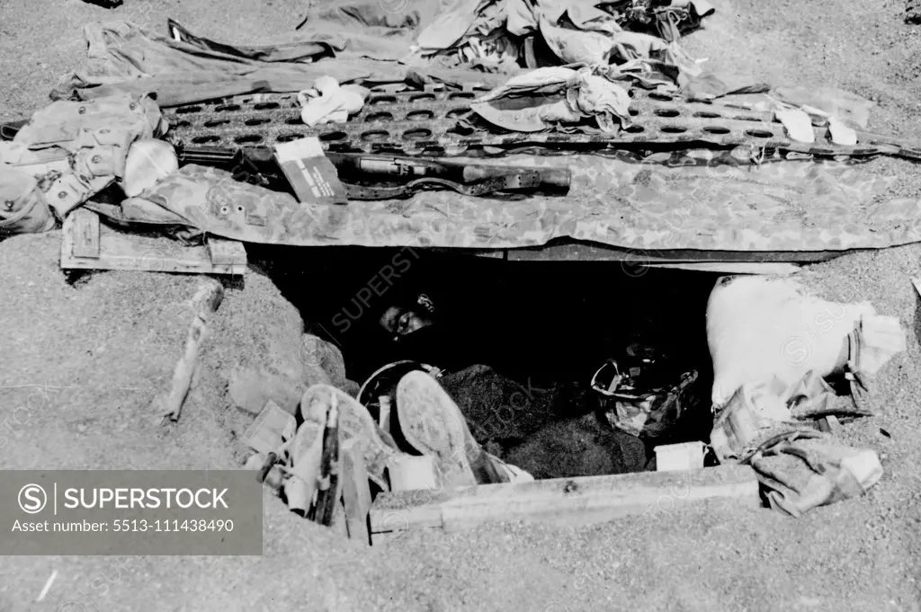 U.S. Marines Sleep In Ornate Iwo Jima Foxhole -- U.S. Marines rest in a foxhole dug into the sand of Iwo Jima, Volcano Island bastion 750 miles (1,200 km) from Tokyo, capital of Japan. The roof of the foxhole has a metal reinforcement of airstrip matting for protection against enemy shrapnel. The Marines landed on Iwo, which was under the administration of the Tokyo Metropolis, on Feb, 18, 1945, and brought an end to organized Japanese resistance on March 15, after a bitter, bloody battle. By Ma