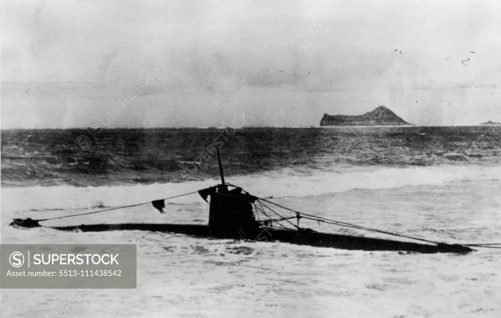 Two-Man Submarine Used By The Japanese In Attack On Pearl Harbor -- The midget craft beached during the battle in Hawaii on December 7th. It has two torpedoes and is said to have been launched from large warship and to carry high explosives. Streamlined vessel operated by two men held to have range of only 200 miles. It is 41 feet long, has a beam of 5 feet and a conning tower 4½ feet above the deck. The hull is constructed of ¼inch plate and divided into 5 compartments, two of which are occupie