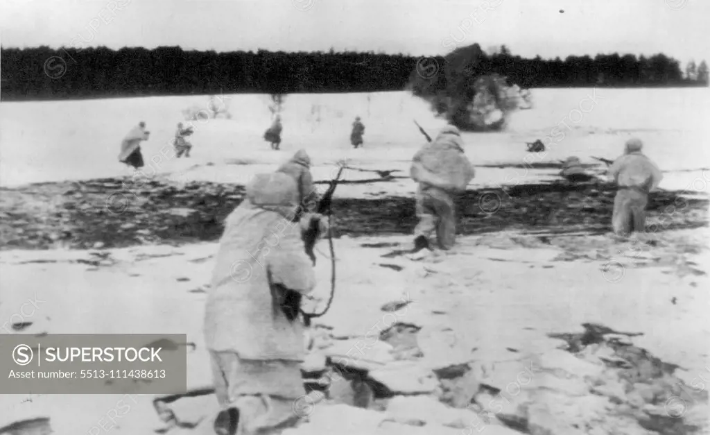 Russian Skirmish Party Moves Forward -- As a shell explodes in the background. Red Army forces attack a forest edge held by Germans somewhere on the Russian front, according to Moscow sources. April 20, 1942. (Photo by AP Wirephoto).