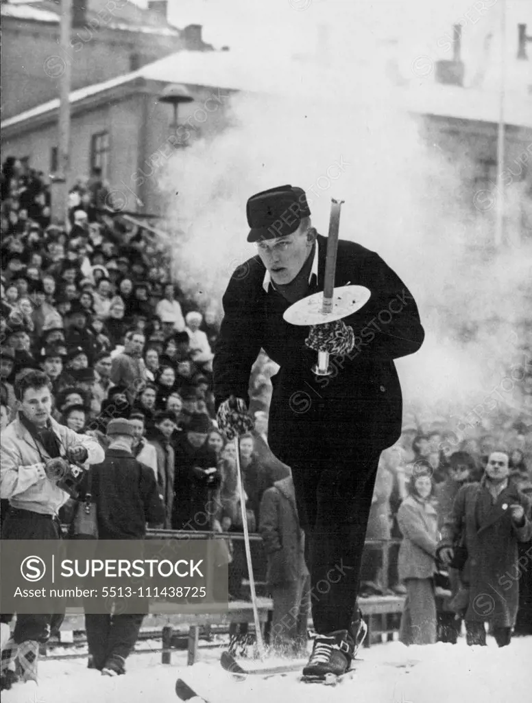 Opening Of The Winter Olympics -- A skier carrying the Olympic Torch arrives at the stadium at Oslo for the opening ceremony at the start of the Winter Olympic Games. February 18, 1952.